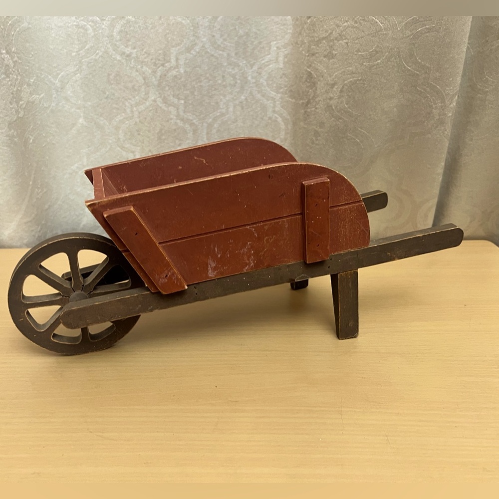 Distressed/rustic wheelbarrow.